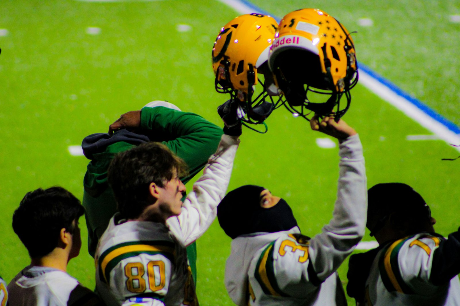 Excited college sports fans cheering in a packed stadium